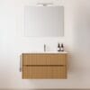 Mobile bagno sospeso in legno chiaro con lavabo bianco e specchio moderno