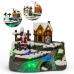 Villaggio natalizio luminoso con Babbo Natale e casetta innevata con luci LED